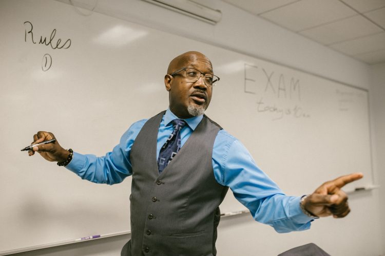 A Professor delivering lecture to the class