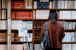 An international student searching a book in the library