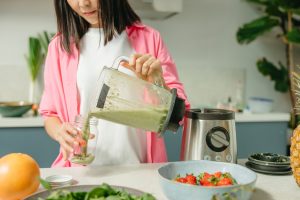 A Woman Taking a Glass of Smoothie